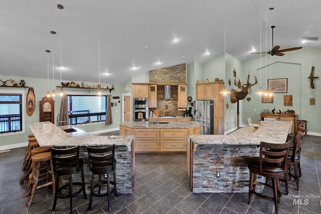 kitchen featuring pendant lighting, a kitchen breakfast bar, wall chimney exhaust hood, and a spacious island