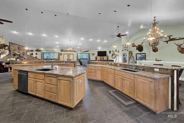 kitchen with ceiling fan with notable chandelier, a spacious island, and sink