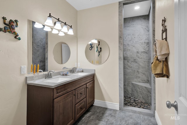 bathroom featuring a tile shower and vanity