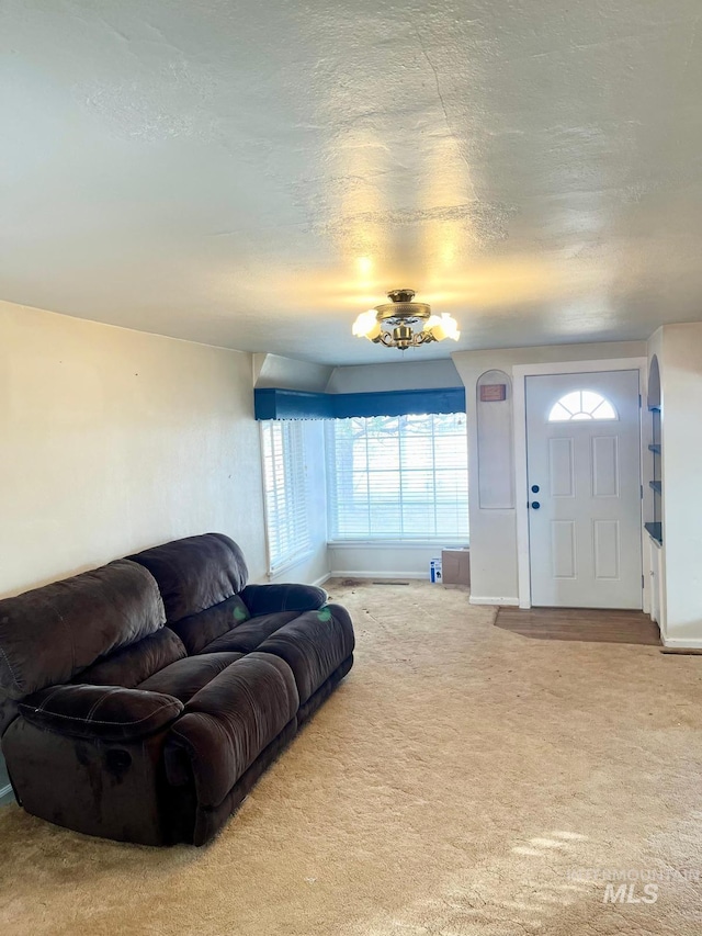 carpeted living area featuring a textured ceiling