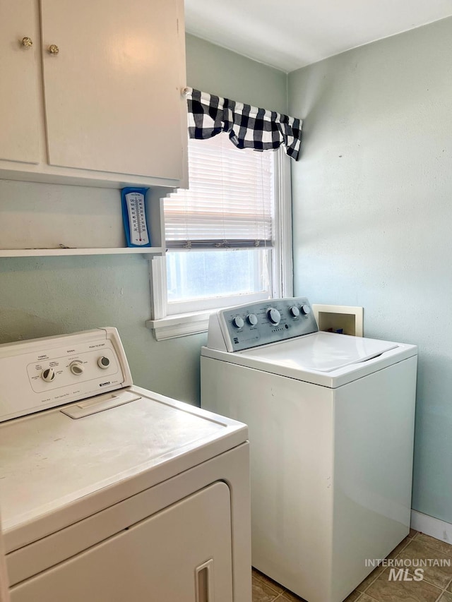 laundry area featuring washing machine and dryer and cabinet space