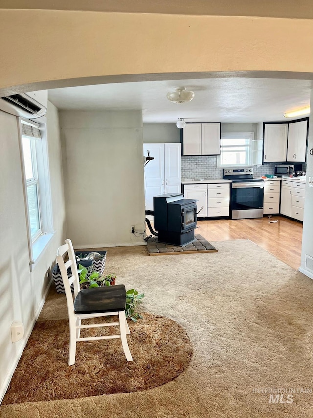 living area with a wood stove and baseboards