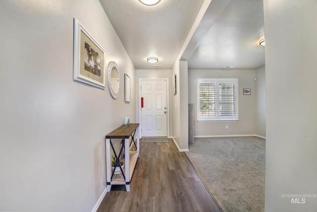 interior space featuring a textured ceiling and hardwood / wood-style flooring