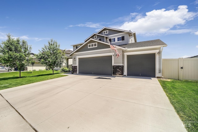 craftsman-style house featuring a garage and a front lawn