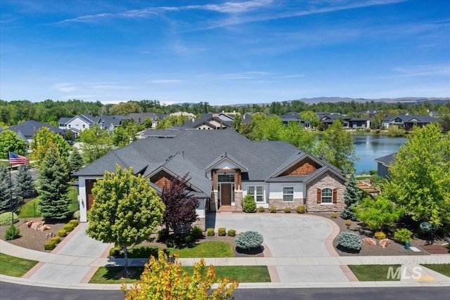 1552 W Windbreaker Ln, Eagle, ID 83616 - view of front of house with curved driveway, stone siding, a residential view, and a water view