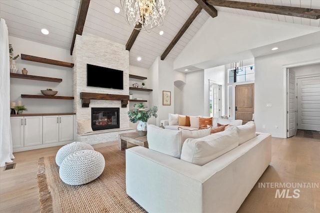 1552 W Windbreaker Ln, Eagle, ID 83616 - living room with a chandelier, light wood-style floors, a fireplace, high vaulted ceiling, and wood ceiling with exposed beams