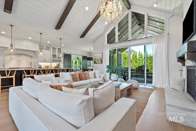 1552 W Windbreaker Ln, Eagle, ID 83616 - living room featuring high vaulted ceiling, recessed lighting, a chandelier, wooden ceiling with exposed beams, and light wood-style floors