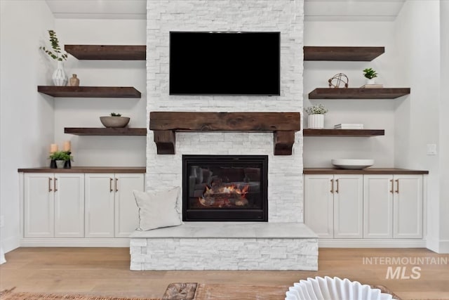 1552 W Windbreaker Ln, Eagle, ID 83616 - living area with light wood finished floors, a fireplace, and baseboards