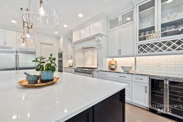 1552 W Windbreaker Ln, Eagle, ID 83616 - kitchen with beverage cooler, built in appliances, white cabinets, backsplash, and recessed lighting