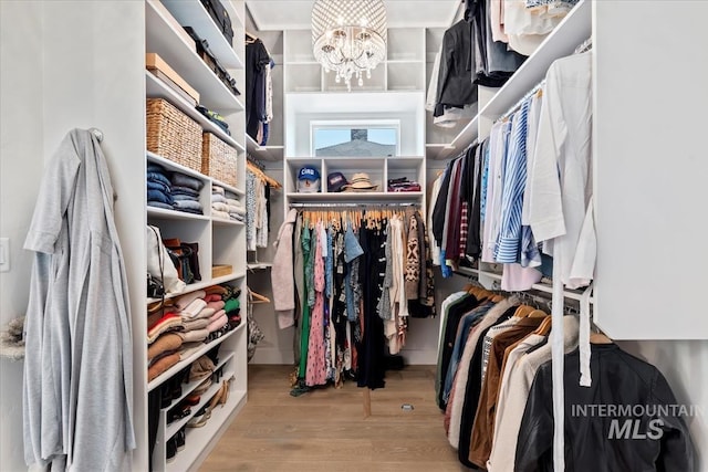 1552 W Windbreaker Ln, Eagle, ID 83616 - spacious closet featuring wood finished floors and a chandelier