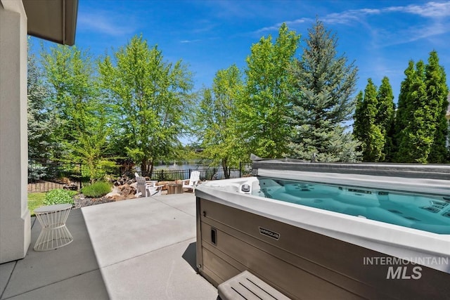 1552 W Windbreaker Ln, Eagle, ID 83616 - view of patio featuring a hot tub and a water view
