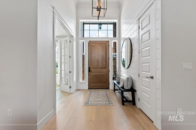 1552 W Windbreaker Ln, Eagle, ID 83616 - foyer featuring light wood-style floors, a chandelier, baseboards, and ornamental molding