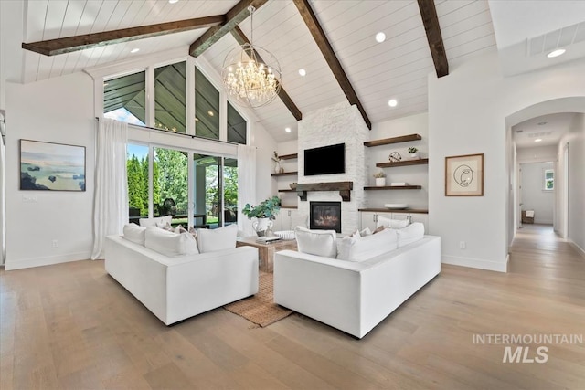 1552 W Windbreaker Ln, Eagle, ID 83616 - living room with high vaulted ceiling, baseboards, arched walkways, light wood-style floors, and wooden ceiling with exposed beams