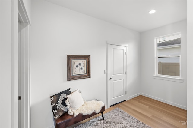 sitting room with light wood-style flooring, baseboards, and recessed lighting