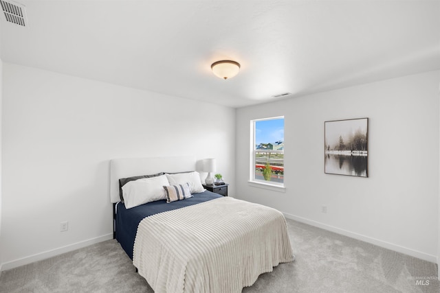bedroom with light carpet and baseboards