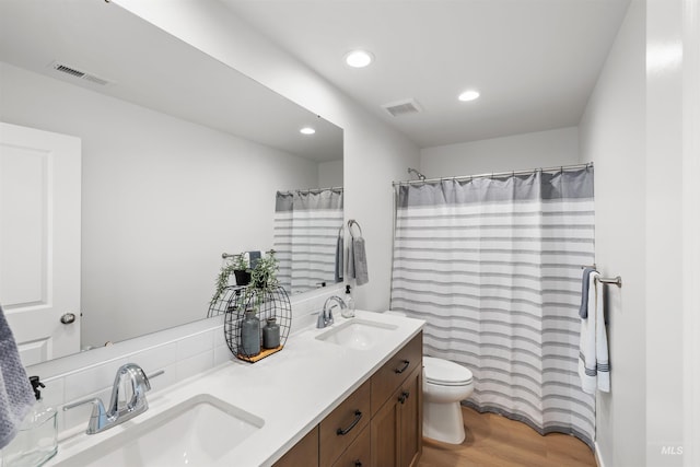 full bathroom with wood finished floors, toilet, recessed lighting, double vanity, and a shower with shower curtain