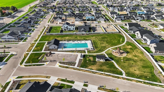 aerial view of property and surrounding area with a pool and nearby suburban area