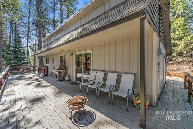 deck with an outdoor fire pit and grilling area