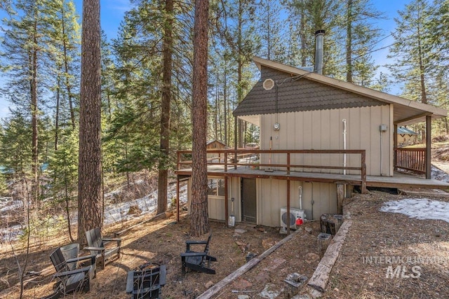 back of property featuring a wooden deck