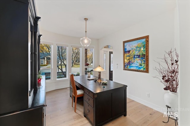 office area with light wood-style flooring and baseboards