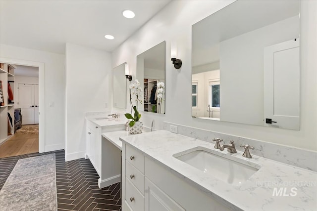 full bath featuring recessed lighting, vanity, baseboards, and a spacious closet