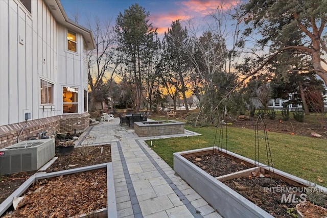 view of yard with central AC unit, a patio area, and a vegetable garden