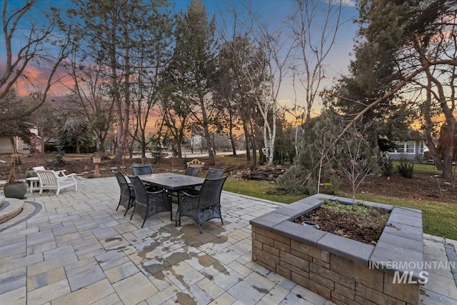 patio terrace at dusk with outdoor dining space