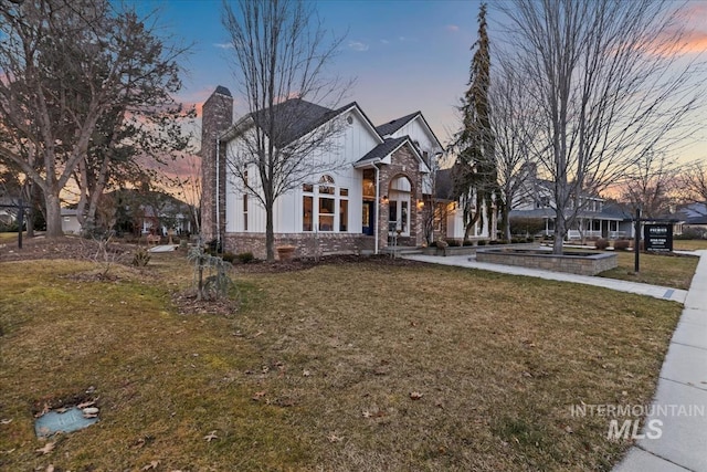 view of front of home with a front lawn and brick siding