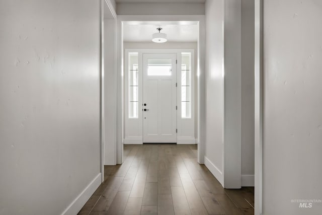 entrance foyer with baseboards and light wood-style flooring