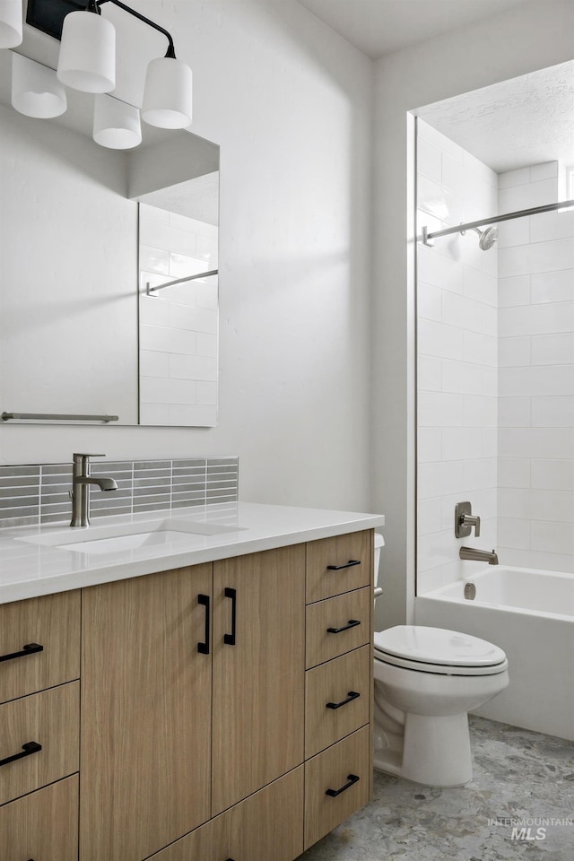 bathroom with vanity, bathing tub / shower combination, and toilet