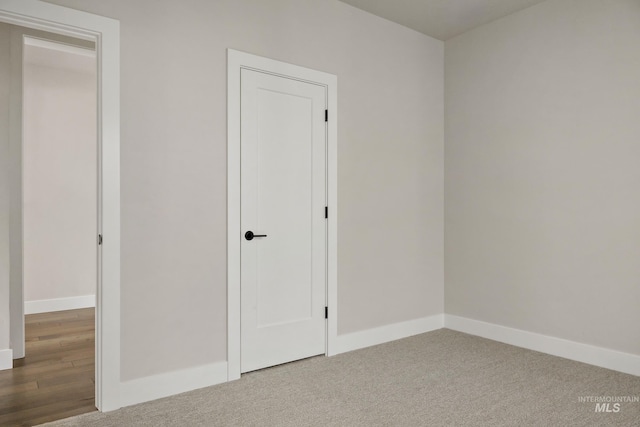 unfurnished bedroom with baseboards and carpet flooring