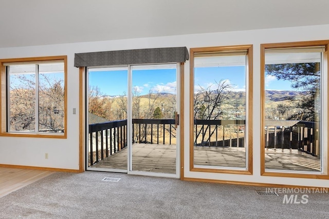 doorway to outside featuring carpet and a mountain view