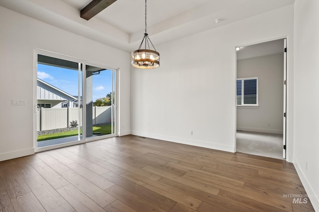 unfurnished room featuring a chandelier, a raised ceiling, wood-type flooring, and beamed ceiling