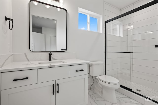 bathroom with toilet, vanity, and walk in shower