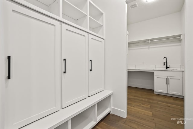 mudroom with dark hardwood / wood-style flooring and sink