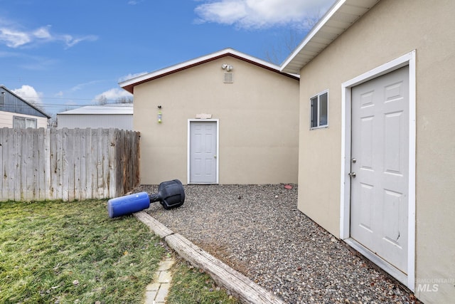 doorway to property with a yard