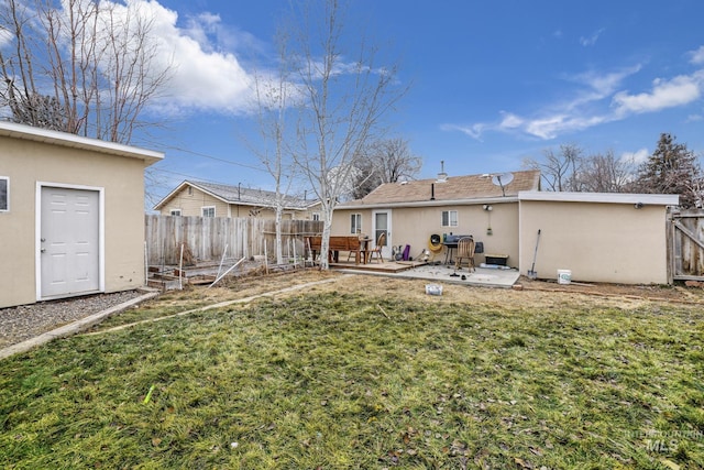 rear view of house featuring a patio area and a yard