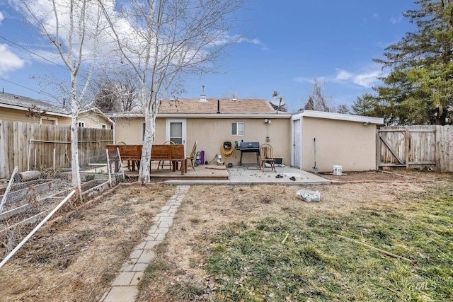 rear view of property featuring a patio area and a deck