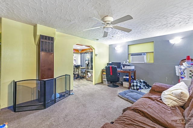 living room with a textured ceiling, carpet floors, cooling unit, and ceiling fan