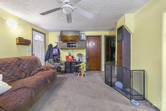 carpeted living room featuring ceiling fan and a textured ceiling