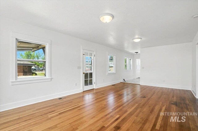 101 E 2nd St, Emmett, ID 83617 - unfurnished living room featuring wood finished floors and baseboards
