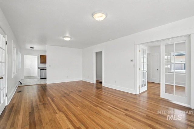 101 E 2nd St, Emmett, ID 83617 - unfurnished living room featuring wood finished floors and french doors
