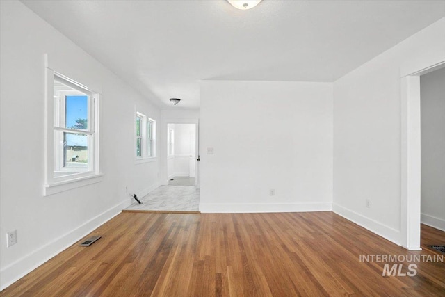 101 E 2nd St, Emmett, ID 83617 - spare room featuring wood finished floors and baseboards
