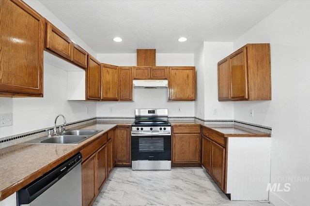 101 E 2nd St, Emmett, ID 83617 - kitchen featuring stainless steel appliances, under cabinet range hood, light marble finish flooring, brown cabinets, and recessed lighting