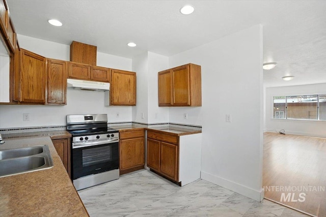 101 E 2nd St, Emmett, ID 83617 - kitchen featuring stainless steel range with electric stovetop, under cabinet range hood, brown cabinetry, light marble finish flooring, and recessed lighting