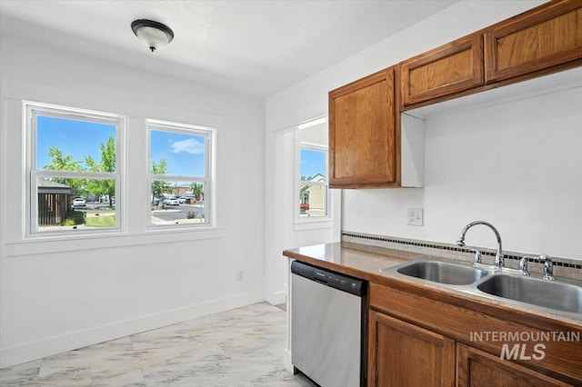 101 E 2nd St, Emmett, ID 83617 - kitchen with stainless steel dishwasher, light marble finish flooring, and brown cabinetry