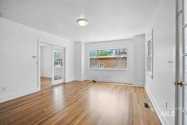 101 E 2nd St, Emmett, ID 83617 - empty room featuring wood finished floors, french doors, and a smoke detector