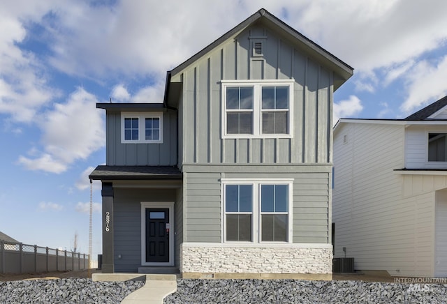 2839 N Rocky Bottom Way, Kuna, ID 83634 - view of front of property featuring fence, cooling unit, stone siding, and board and batten siding