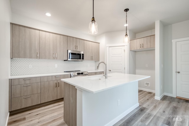 2839 N Rocky Bottom Way, Kuna, ID 83634 - kitchen with a sink, stainless steel appliances, light brown cabinetry, decorative backsplash, and light wood-style floors