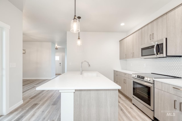2839 N Rocky Bottom Way, Kuna, ID 83634 - kitchen with a sink, backsplash, light countertops, modern cabinets, and appliances with stainless steel finishes